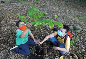 Colombian environmentalist Francisco Vera (L) plants a tree with a fellow activist to mark Earth Day, in Villeta, Colombia