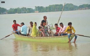 Residents move to a safer place on a boat from a flood affected area following incessant monsoon rainfall, at Shekhpur Dhab in Bihar’s Muzaffarpur district on July 5, 2021