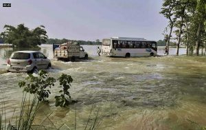Vehicles wade through a flooded area during the monsoon season, in Motihari, Bihar, on July 5, 2021