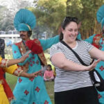 A foreigner dances along with folk artistes