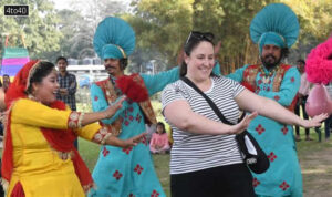 A foreigner dances along with folk artistes