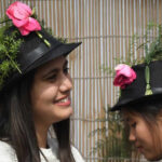 Girls don caps decorated with roses