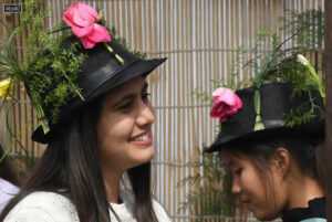 Girls don caps decorated with roses