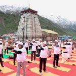 Hindu devotees perform yoga on the occasion of 8th International Day of Yoga at the Kedarnath Temple in Kedarnath on June 21, 2022