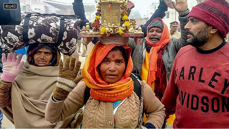A woman devotee from Maharashtra, carrying a Tulsi plant on her head arrive to offer prayers at the Shri Ram Janmabhoomi Temple
