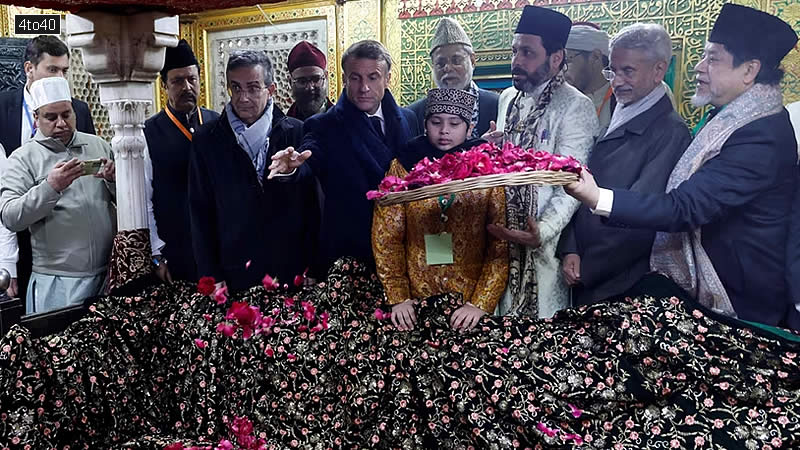 France's President Emmanuel Macron takes part in rituals during his visit of a mausoleum at the Nizamuddin site in New Delhi on January 26