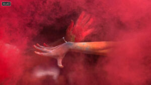 A girl throws colored powder on her friend as they celebrate Holi, the Hindu festival of colors, in Mumbai, India, Friday, March 14, 2025