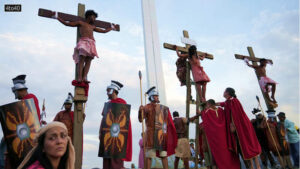 Penitents were depicted hanging on crosses in a powerful reenactment of the Way of the Cross during Holy Week celebrations