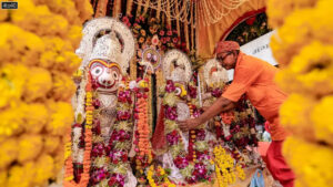 A priest attends to the idols of Lord Jagannath, Lord Balabhadra and Goddess Subhadra