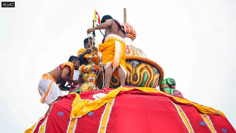 Priests adorn the chariot of Lord Jagannath with a floral garland on the occasion of Mahaprabhu Jagannath Rath Yatra at Puri Jagannath temple, in Puri