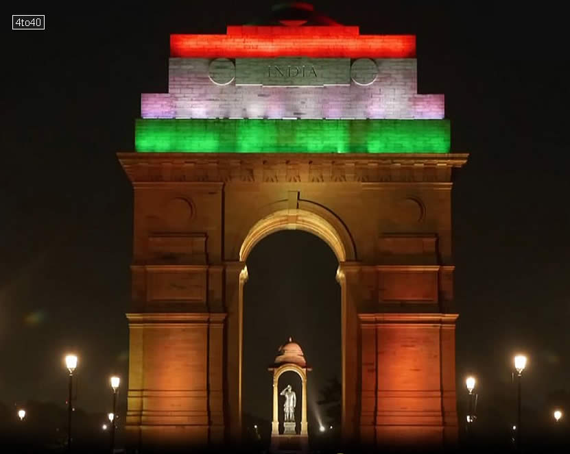 The iconic India Gate in New Delhi is illuminated in the vibrant saffron, white, and green colors